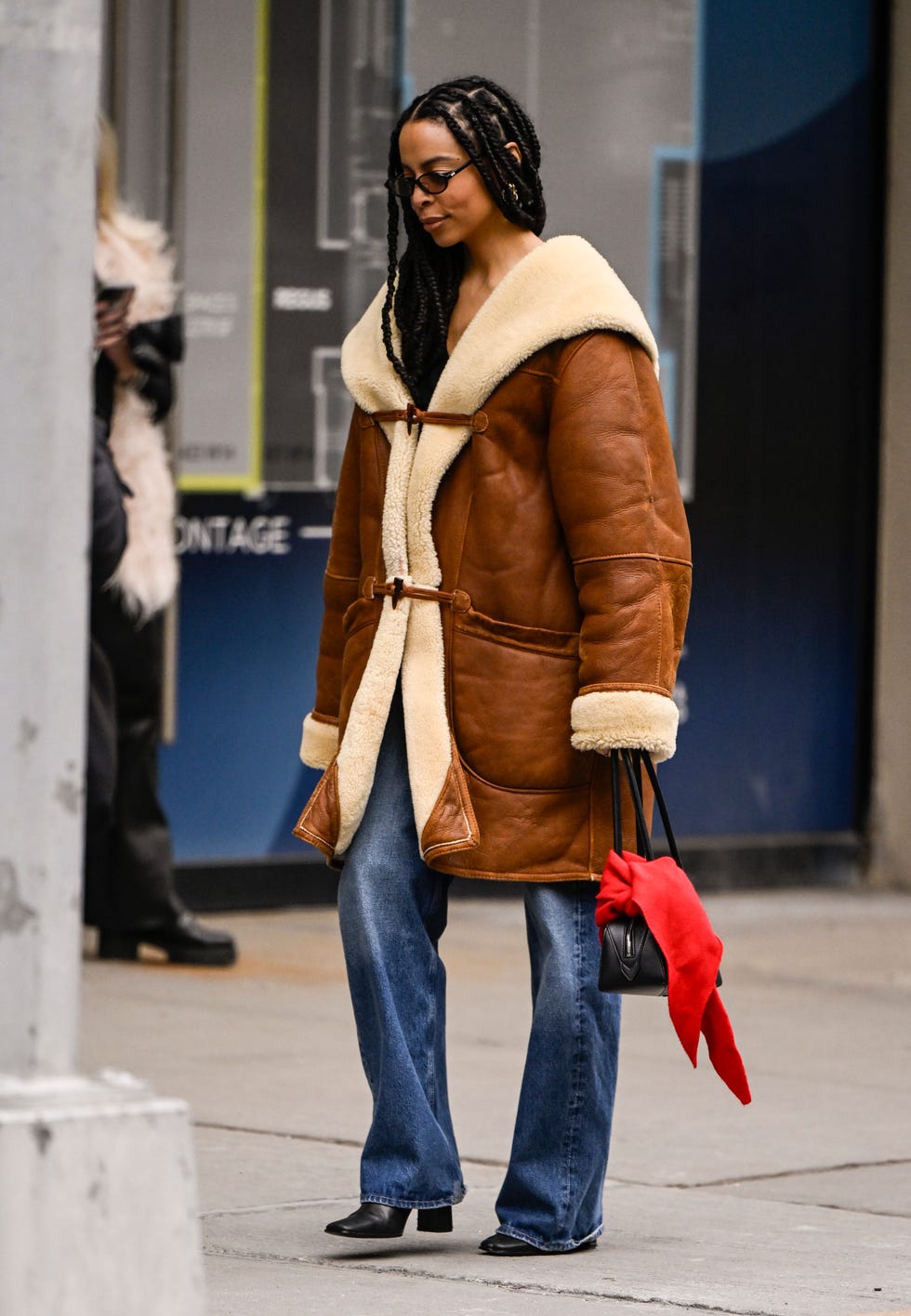 New York, New York 08 février Un invité est vu portant un manteau de garniture en fausse fourrure, un jean bleu, un sac noir avec une écharpe rouge et des chaussures noires à l'extérieur de la présentation Alice et Olivia pendant NYFW FW 2025 le 08 février 2025 à New York Photo City Par Daniel Zuchnikgetty Images