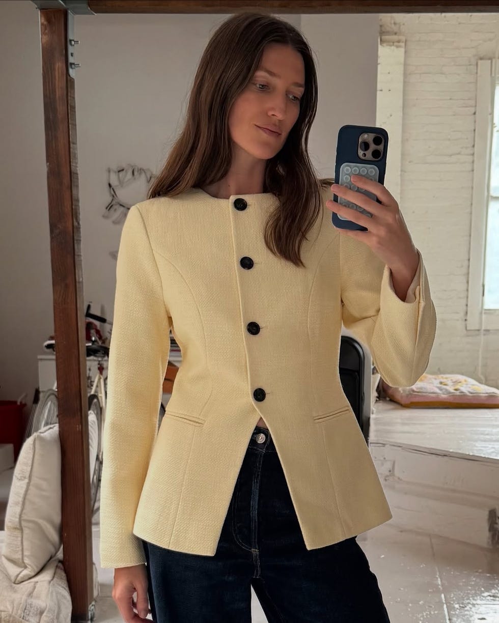 Une personne portant la veste jaune d'Aligne avec des boutons et des jeans foncés