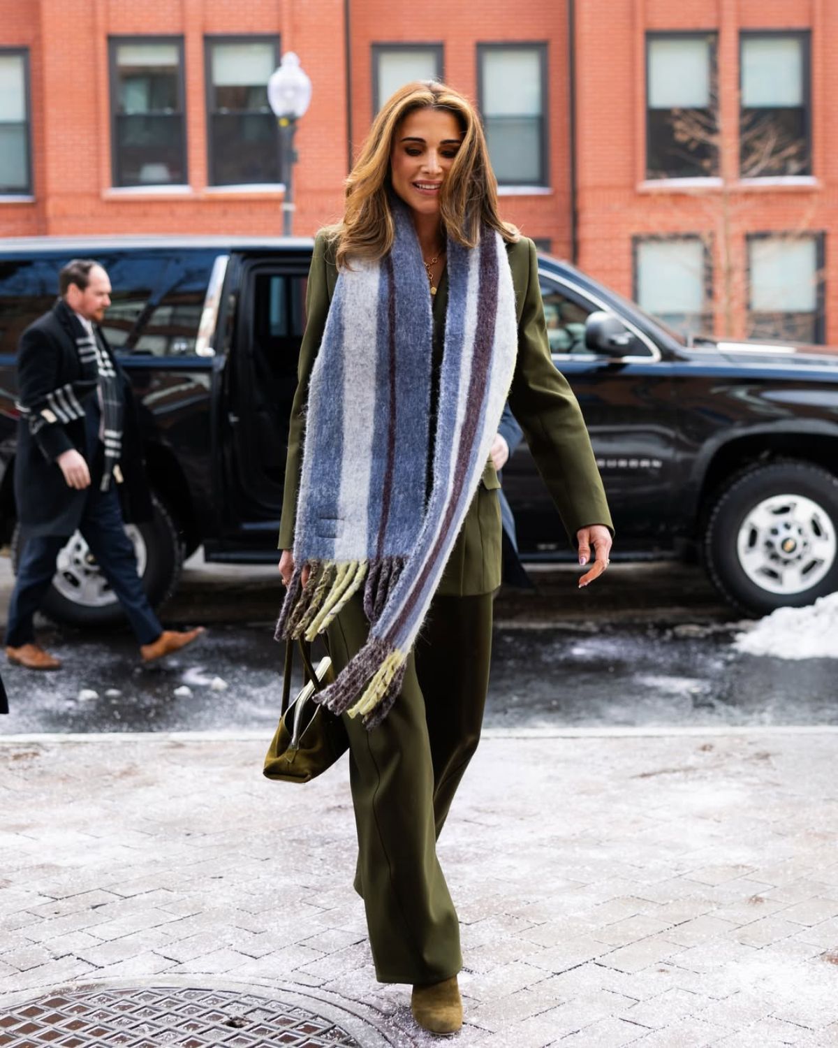 Rania de Jordanie dans un costume vert et une écharpe Loewe.