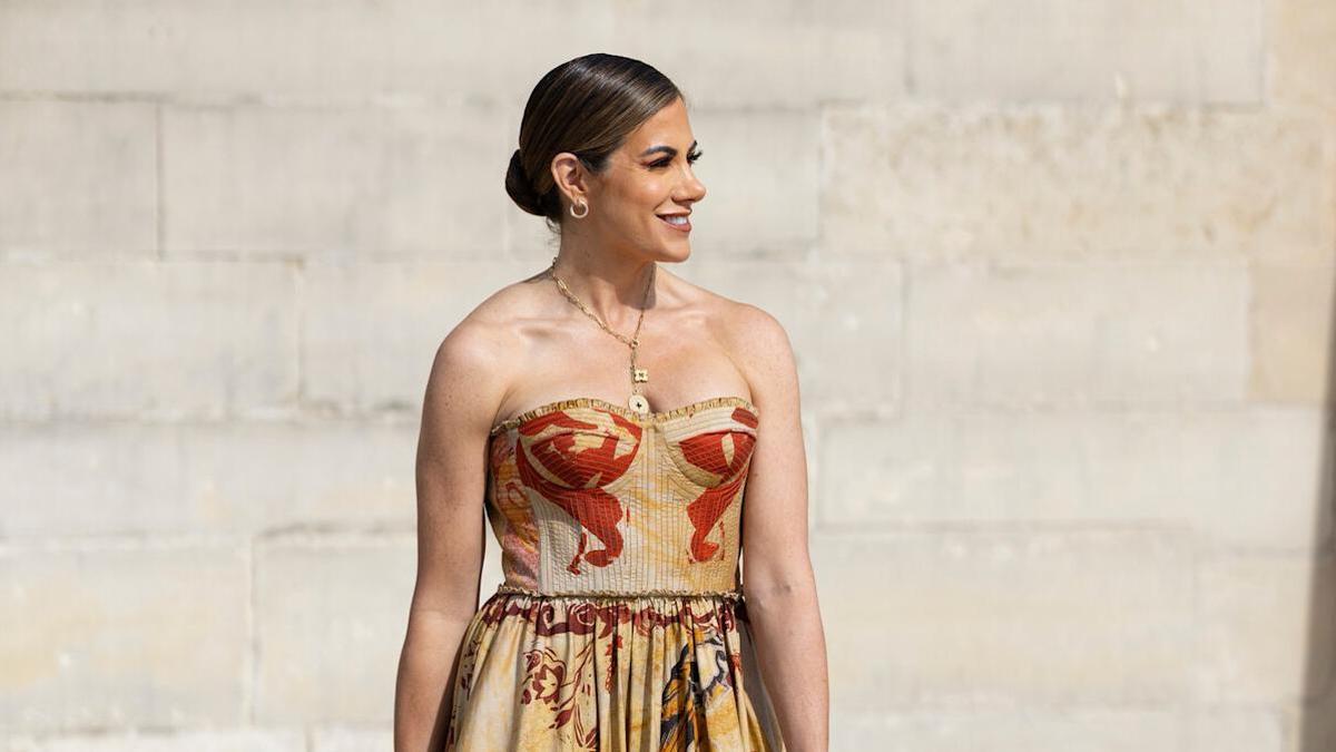 Look de street style formado por un vestido palabra de honor en tonos tierras y estampado